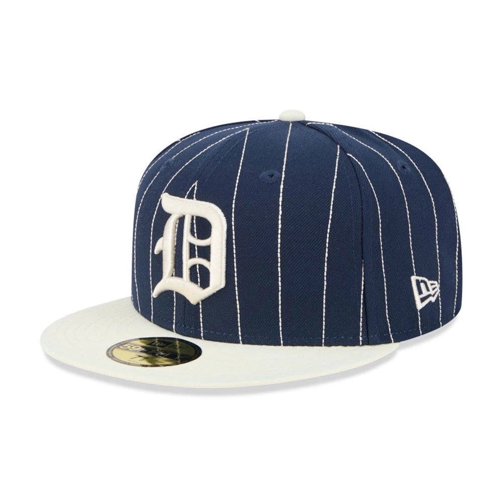 Detroit Tigers MLB Stripes Dark Blue New Era 59FIFTY Fitted Cap, three-quarter view showing the white embroidered D logo on the front panel, a cream flat visor with gold 59FIFTY size sticker, and white pinstripes on the dark blue crown.