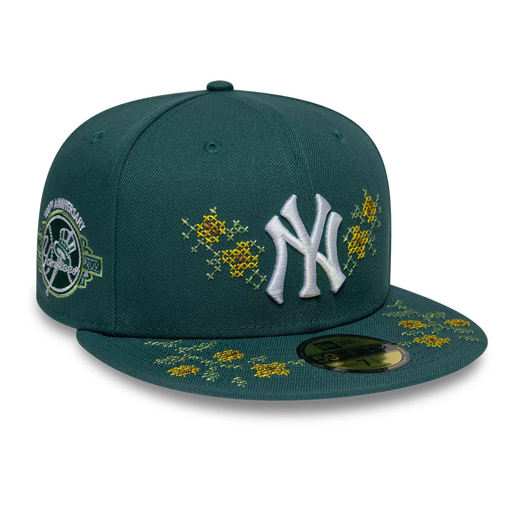 New York Yankees MLB Garden Dark Green New Era 59FIFTY Fitted Cap, three-quarter view showing a white raised NY logo on the front panel, yellow floral embroidery across the crown and visor, and a 59FIFTY size sticker on the dark green visor.