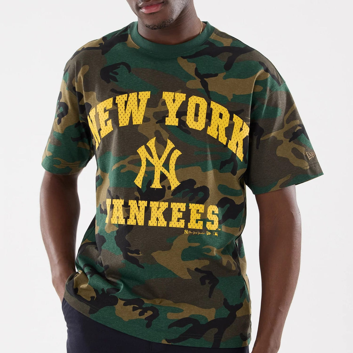New York Yankees MLB Camo Woodland T-Shirt, front view showing a green and brown camouflage pattern, bold yellow "New York Yankees" text and logo across the chest and an embossed New Era logo on the left sleeve.