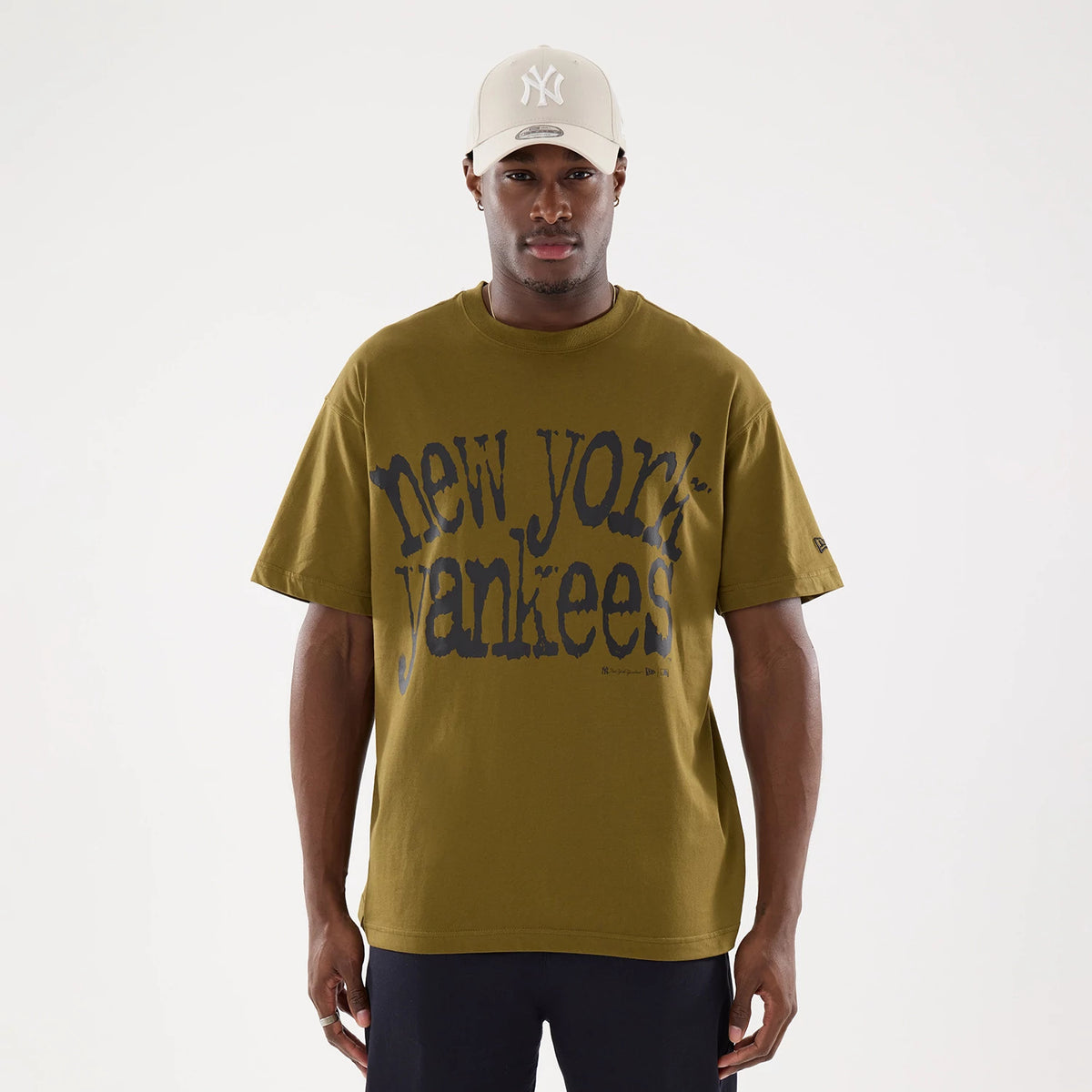 New Era New York Yankees MLB Green T-Shirt, front view showing large blue vintage-style new york yankees text across the chest and a small debossed New Era logo on the left sleeve near the hem.
