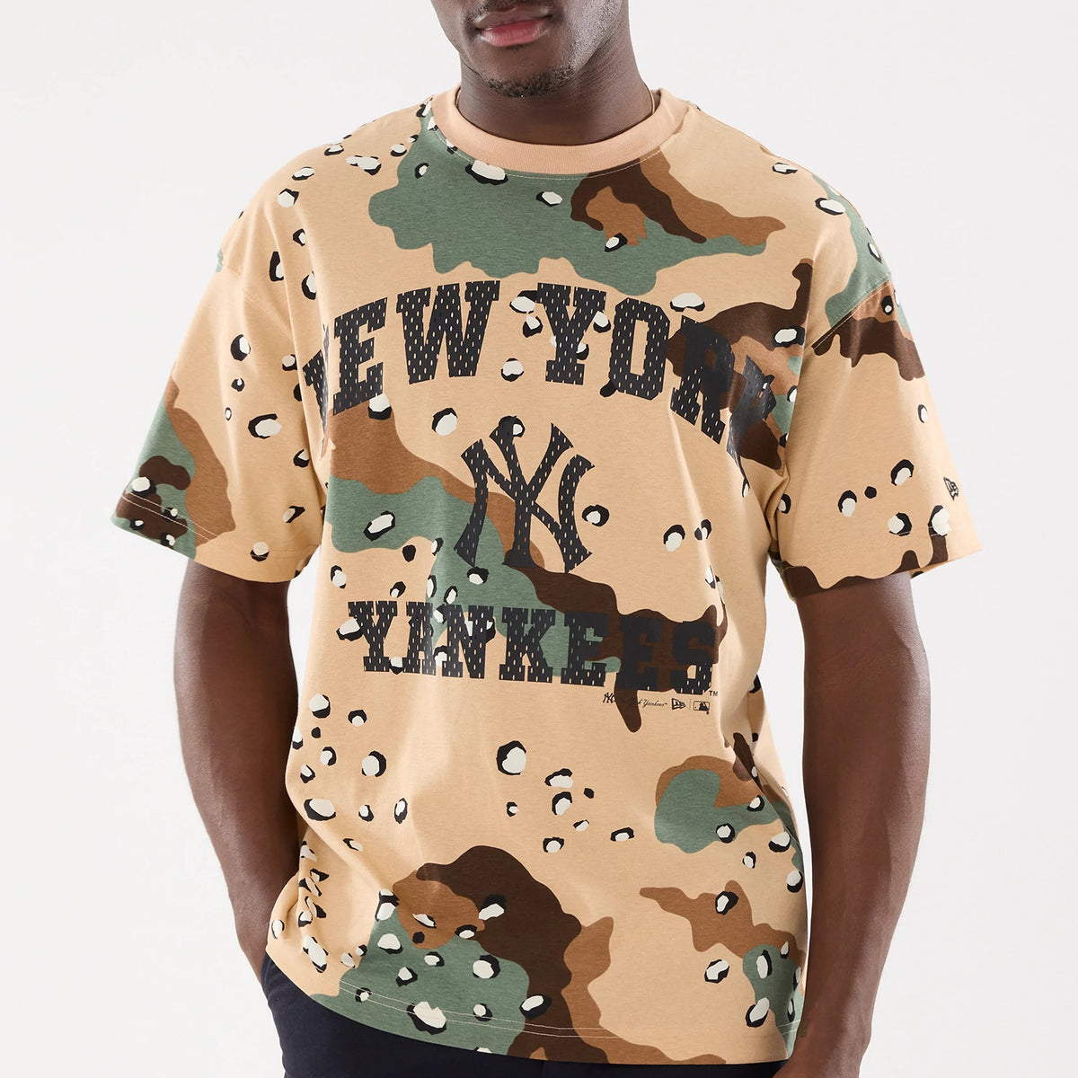 New York Yankees MLB Camo Desert Camo T-Shirt, front view showing a desert camouflage pattern in beige, green, and brown with a large black outlined New York Yankees logo and text across the chest.