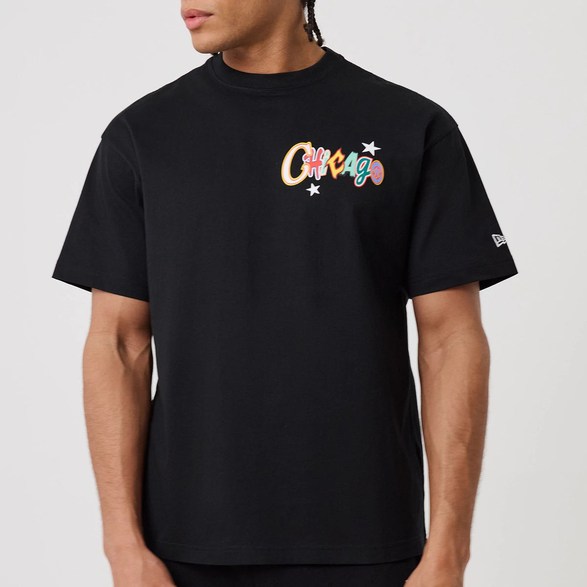 Chicago Bulls MLB Word Art Black T-Shirt, front view showing the colourful "Chicago" text with stars embroidered on the chest and a small white embroidered New Era logo on the left sleeve against a black fabric.