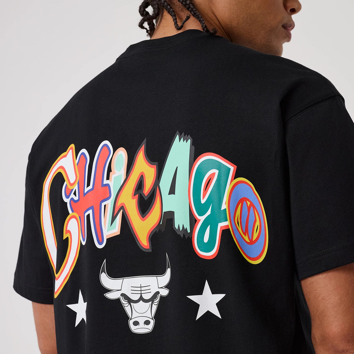 Chicago Bulls MLB Word Art Black T-Shirt, rear view showing large multicoloured "Chicago" lettering across the back, a white Bulls logo and two white stars below the text on the black fabric.