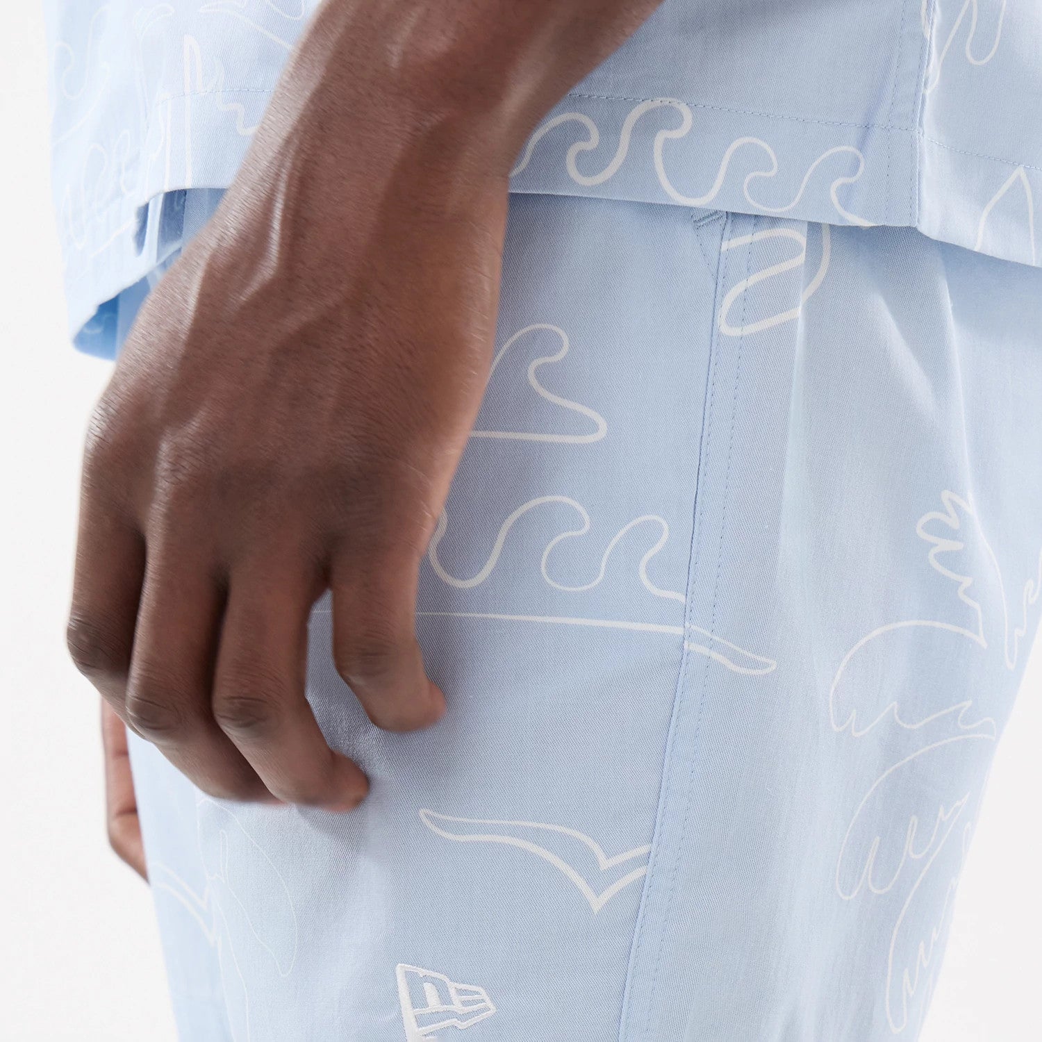 The model is wearing these New Era Resort Oversized Shorts in blue. 4
