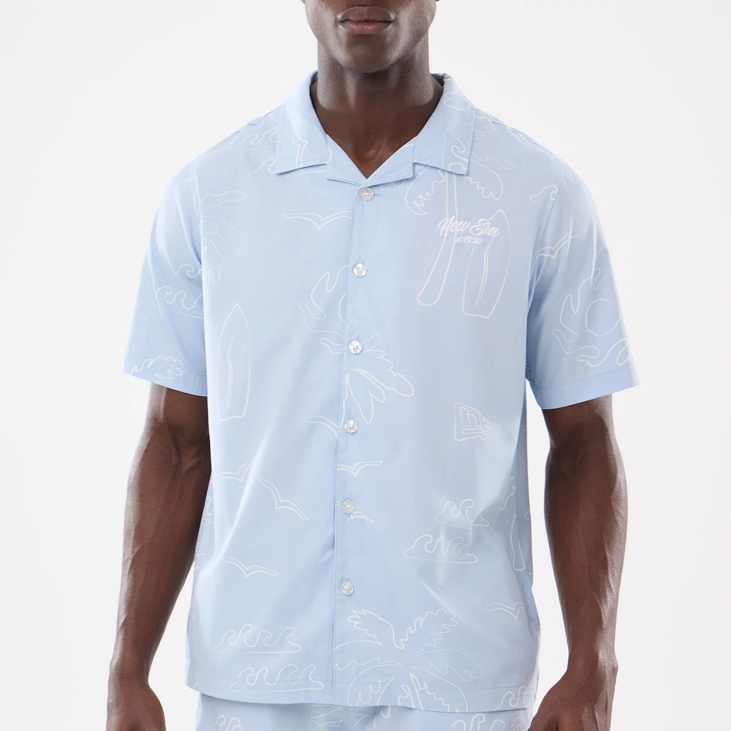 The model is wearing this New Era Resort Short Sleeve Shirt in blue. 3