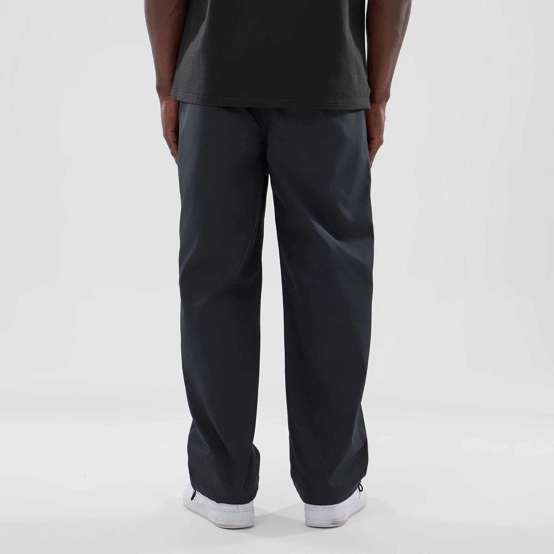 The model is wearing this New Era NEC Logo Straight Leg Joggers in black. 2