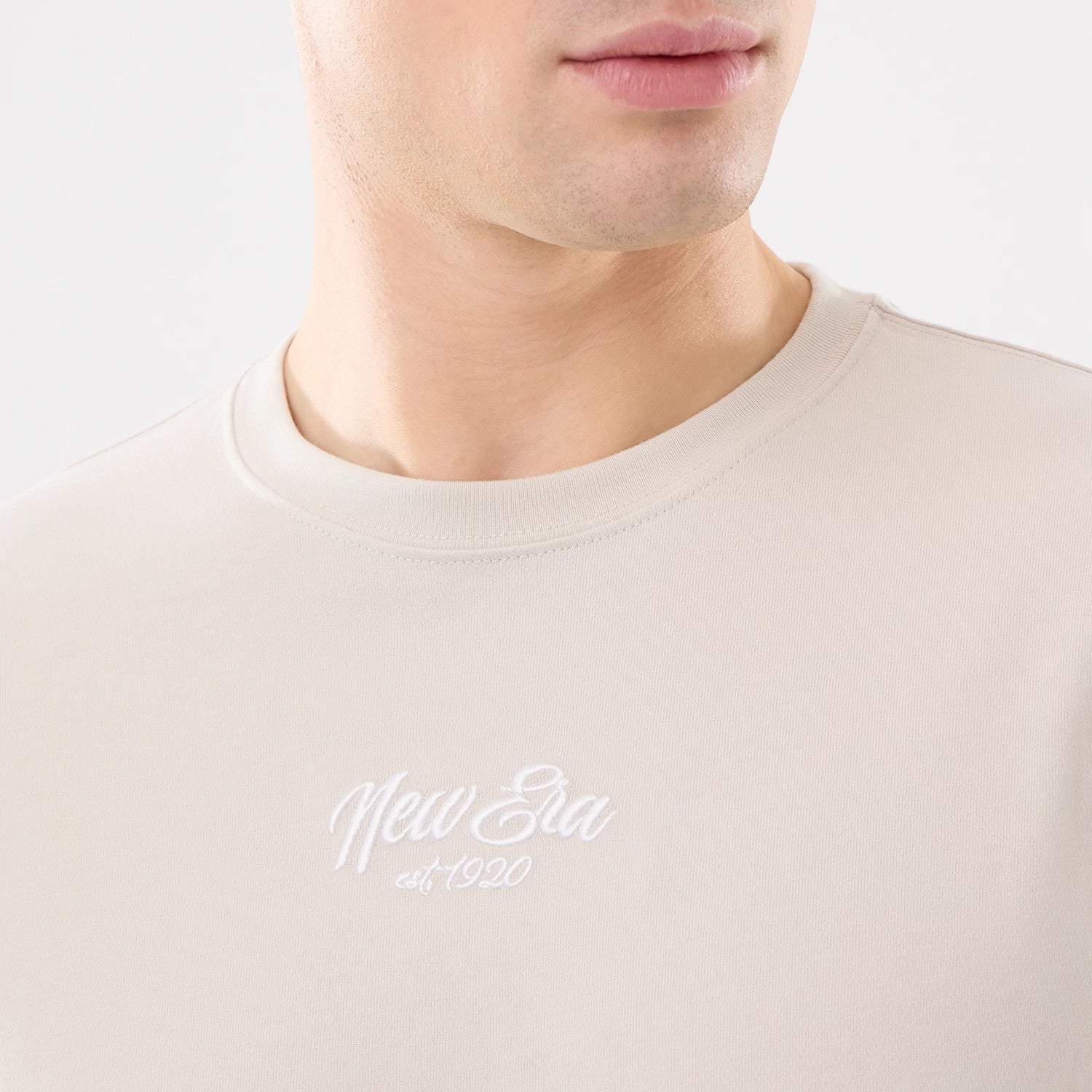 The model is wearing this New Era Resort T-Shirt in natural. 3