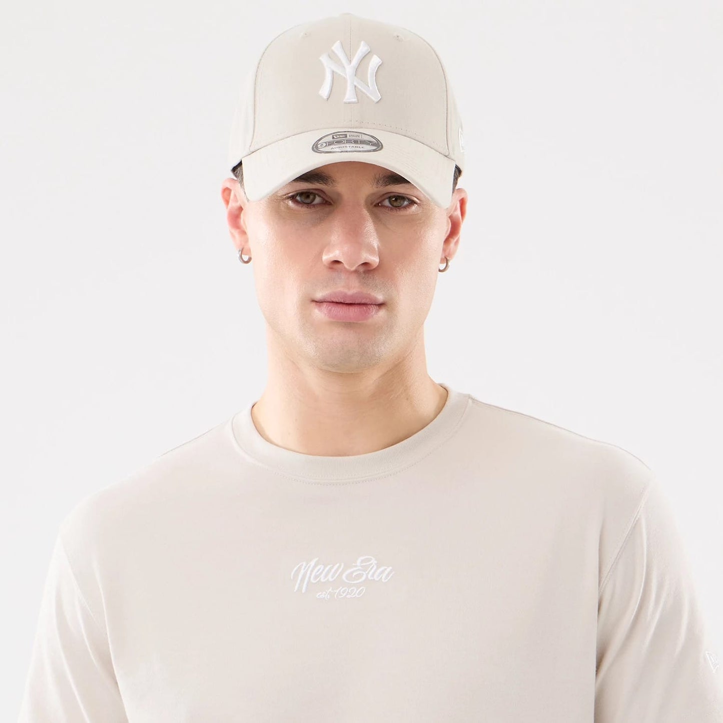 The model is wearing this New Era Resort T-Shirt in natural. 7