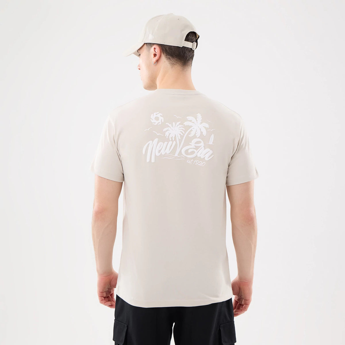 The model is wearing this New Era Resort T-Shirt in natural. 2