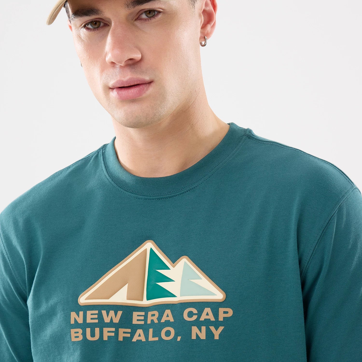 The model is wearing this New Era Outdoor Mountain T-Shirt in dark green. 3
