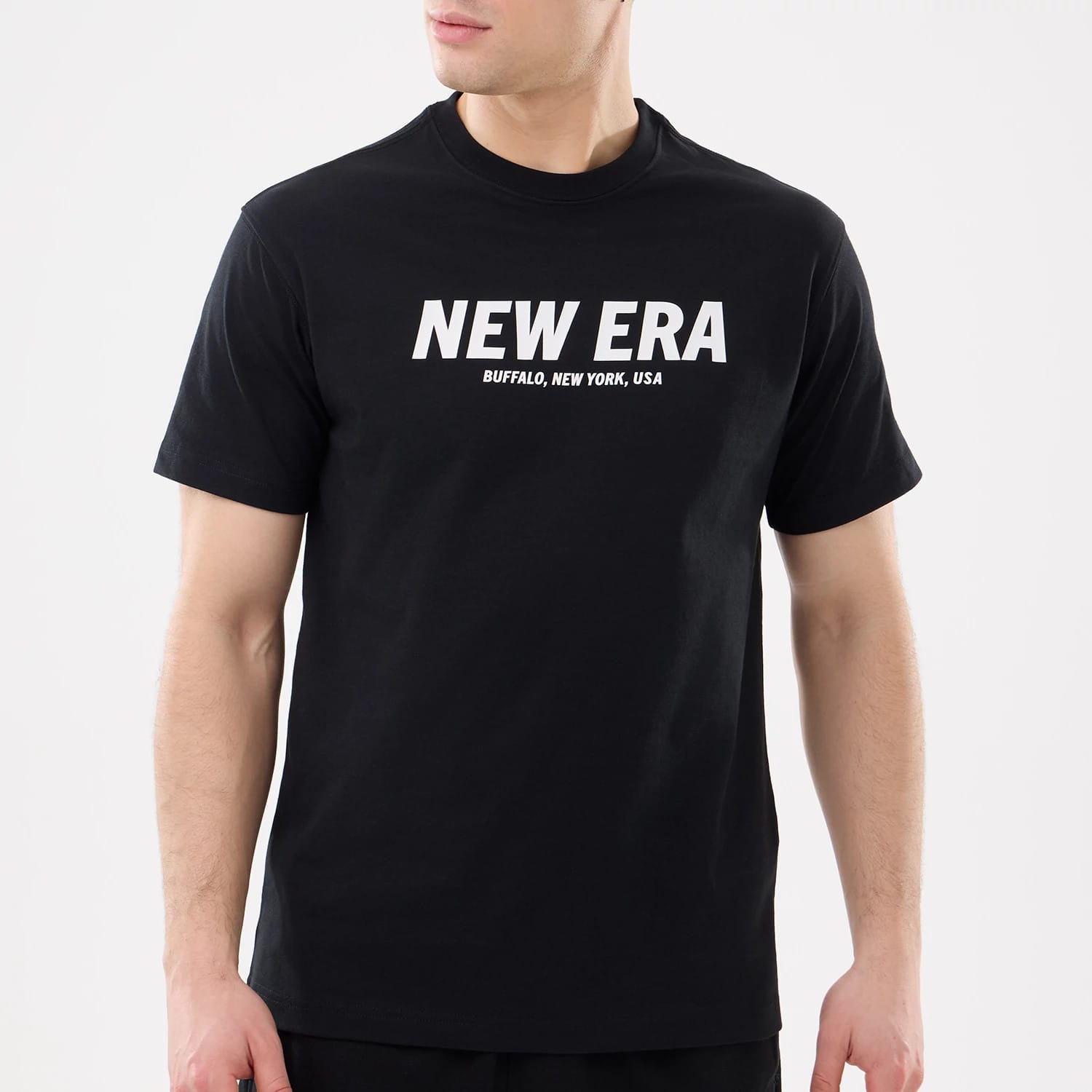 The model is wearing this New Era Basic T-Shirt in black. 3