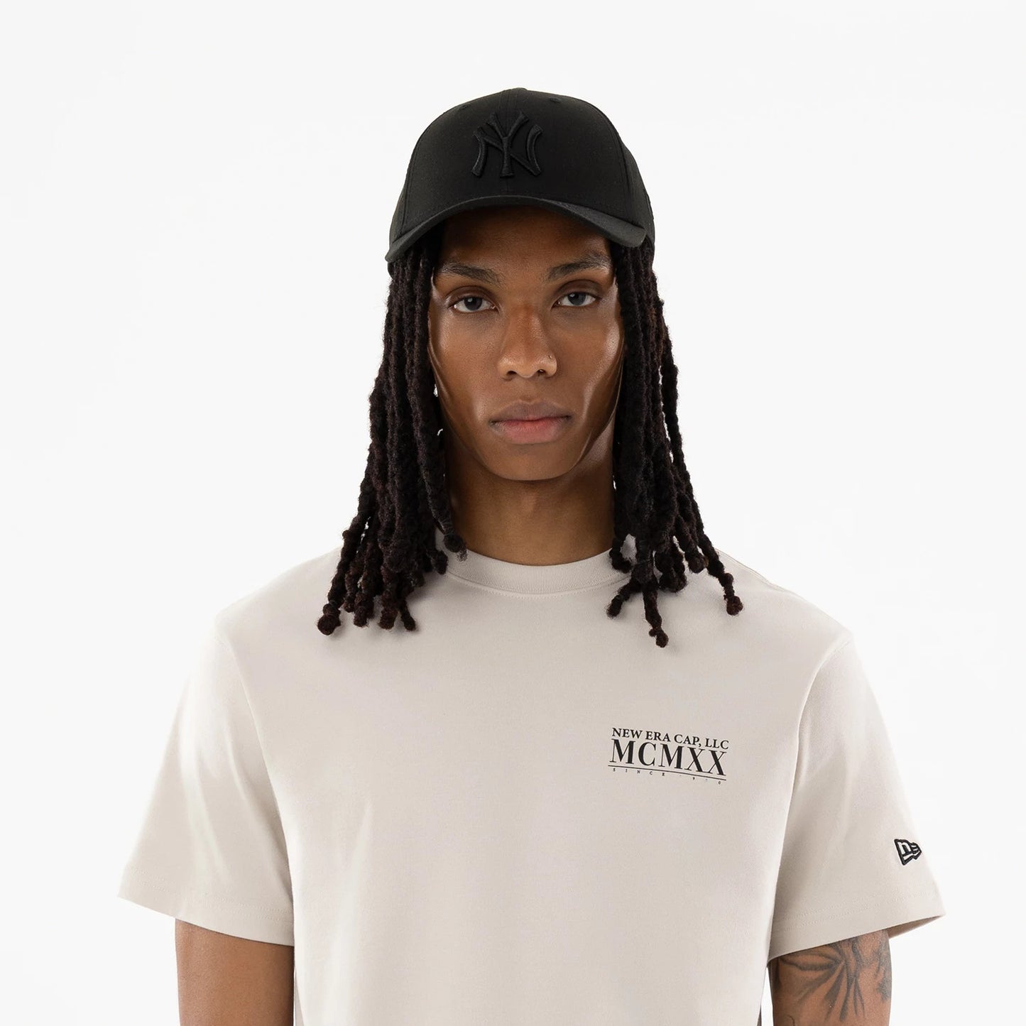 The model is wearing this New Era Heritage T-Shirt in Cream. 7