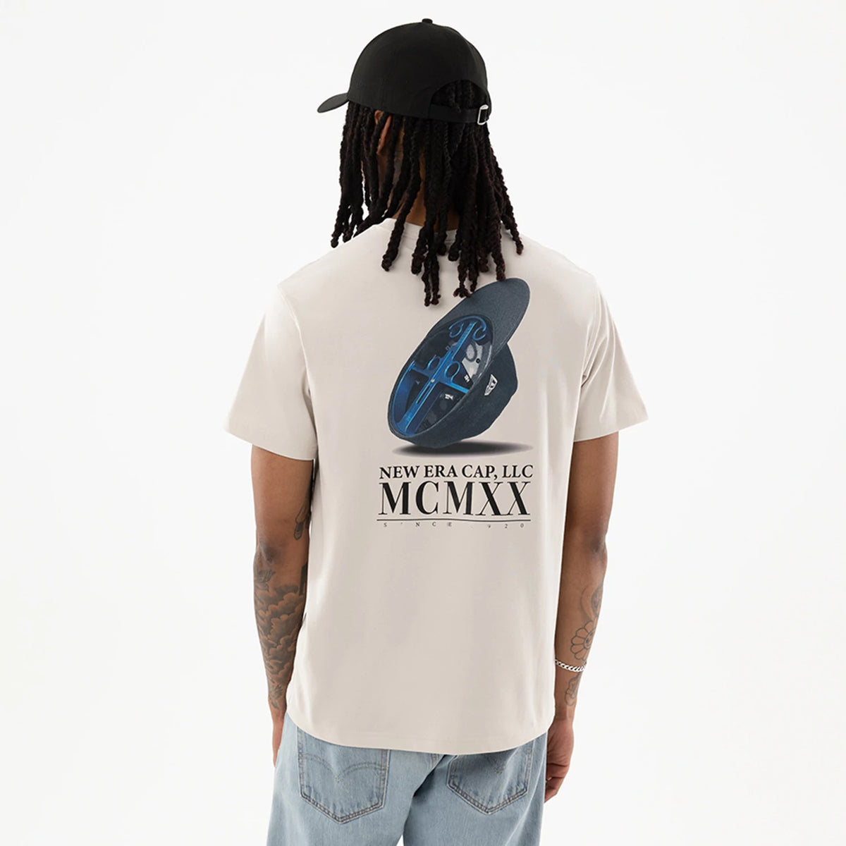 The model is wearing this New Era Heritage T-Shirt in Cream. 2