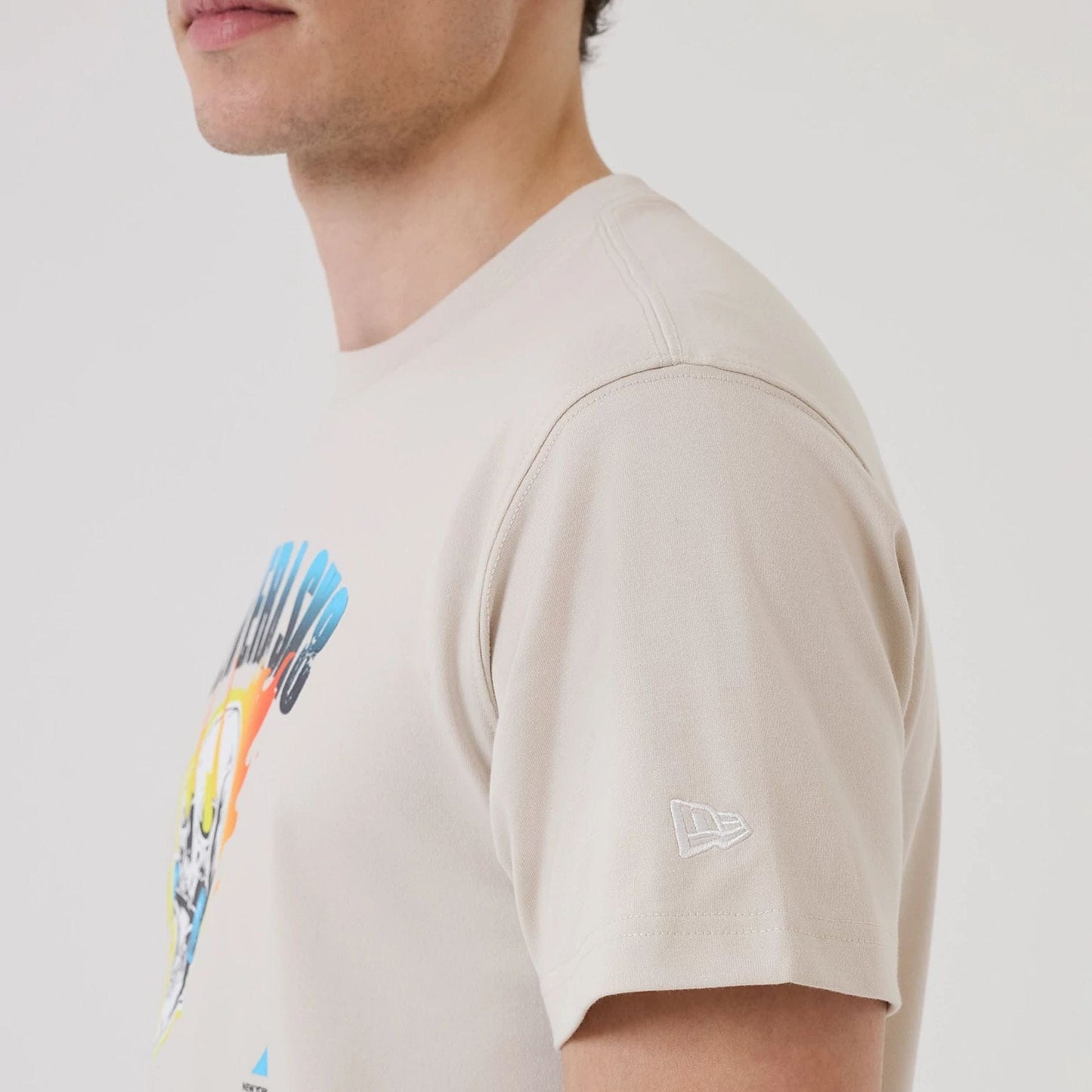 The model is wearing this New Era SK8 Graphic T-Shirt in Cream. 7