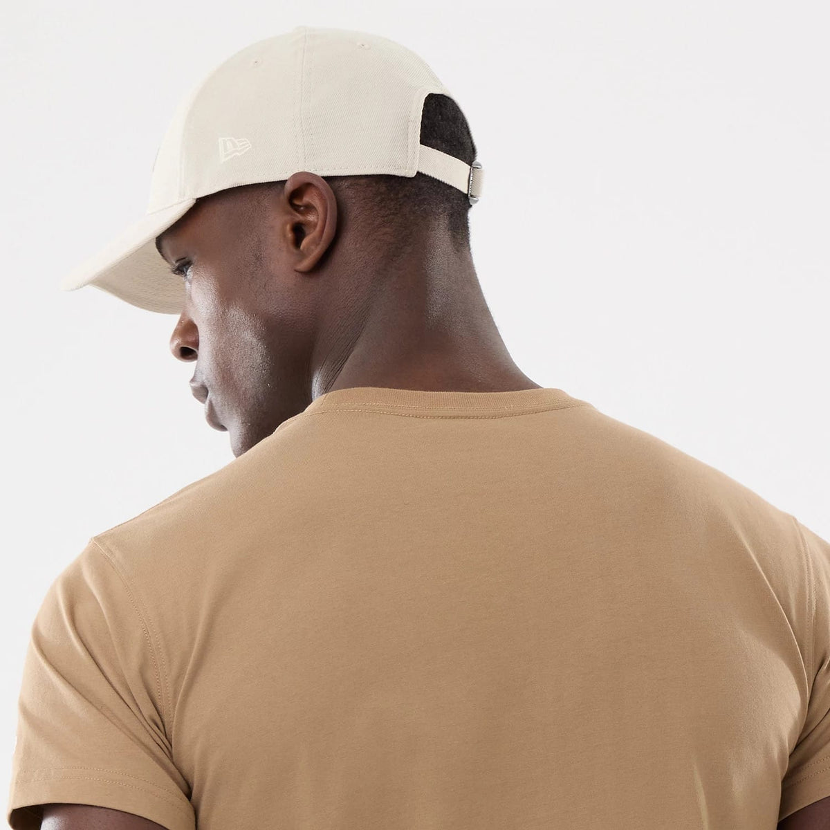 The model is wearing this New Era Earth Day T-Shirt in beige/khaki. 7