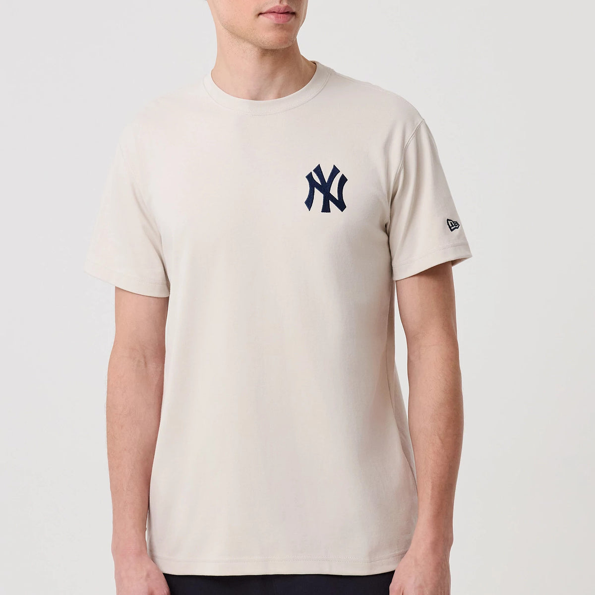 New York Yankees MLB Banana Graphic Natural T-Shirt, front view showing a natural-coloured tee with a navy blue New York Yankees logo on the left chest and an embroidered New Era logo on the left sleeve.
