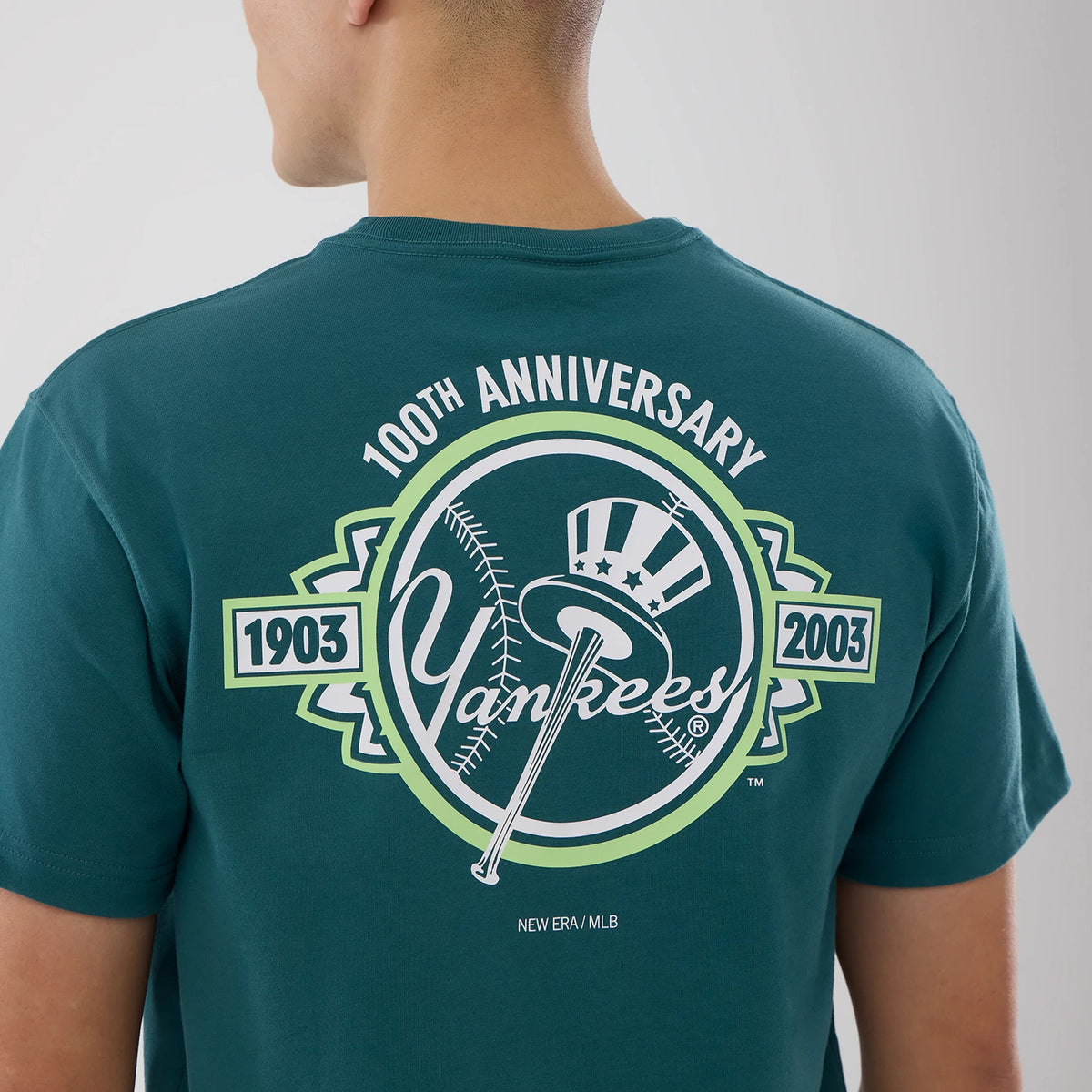 New York Yankees MLB Garden Dark Green T-Shirt, rear view showing a large printed Yankees graphic with a baseball bat and top hat, celebrating the 100th anniversary with the years 1903 and 2003 on a dark green fabric.