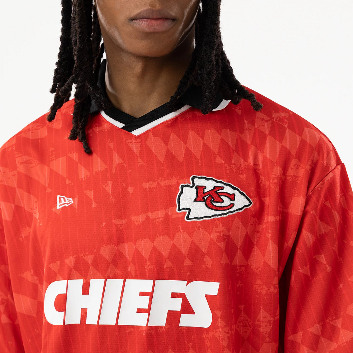 Kansas City Chiefs NFL Red Soccer Jersey, front view on a model showing the black and white collar, embroidered Chiefs logo on the left chest, New Era flag logo on the right chest, and CHIEFS lettering across the front.