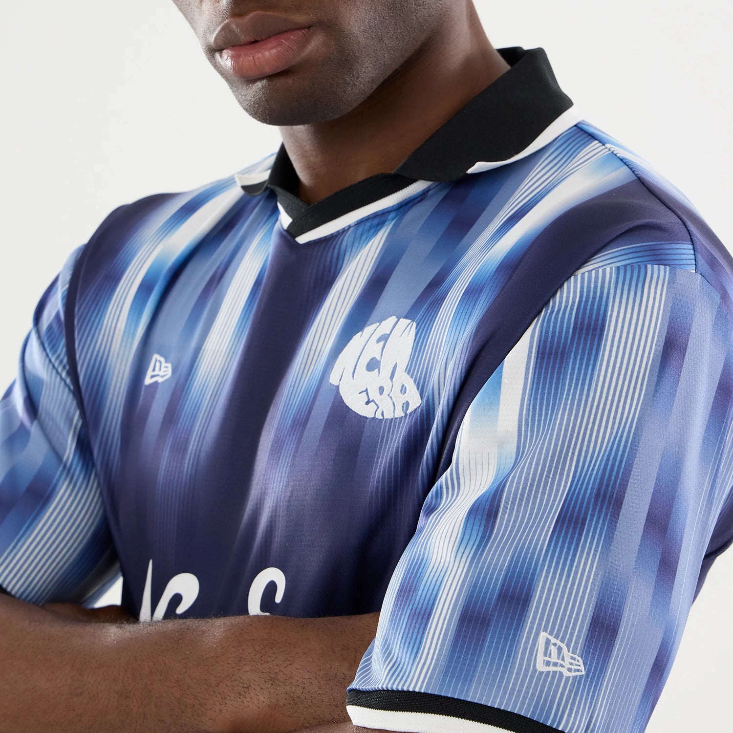 The model is wearing this New Era Soccer Jersey in navy. 4