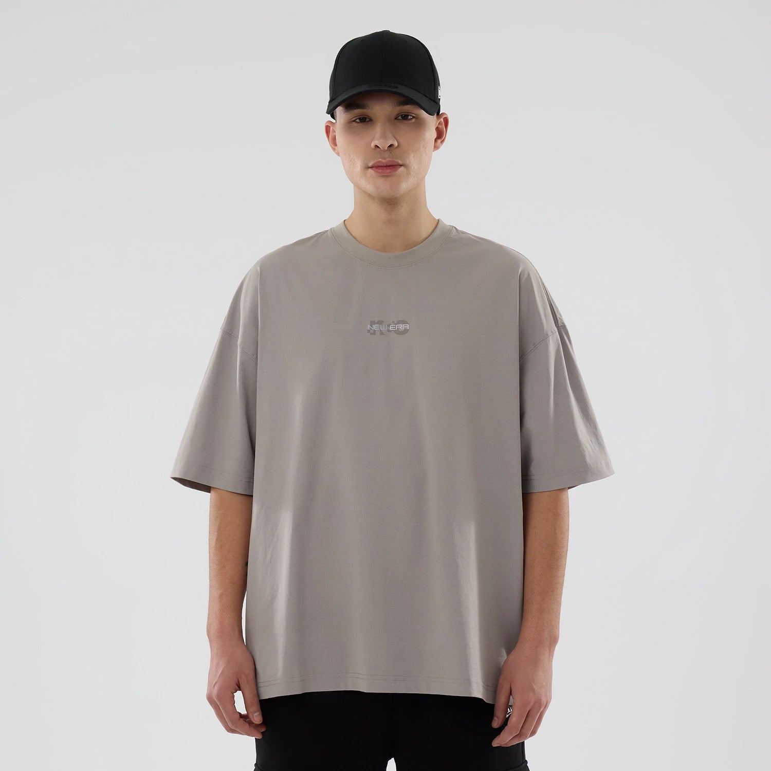 The model is wearing this New Era NEC Logo Oversized T-Shirt in Beige. 1