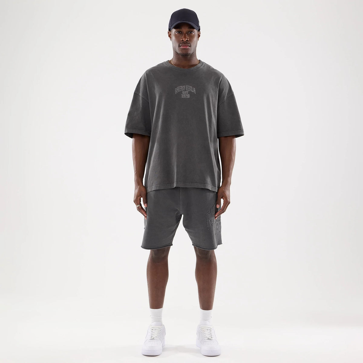 The model is wearing this New Era Street Archived Oversized T-Shirt in black. 8