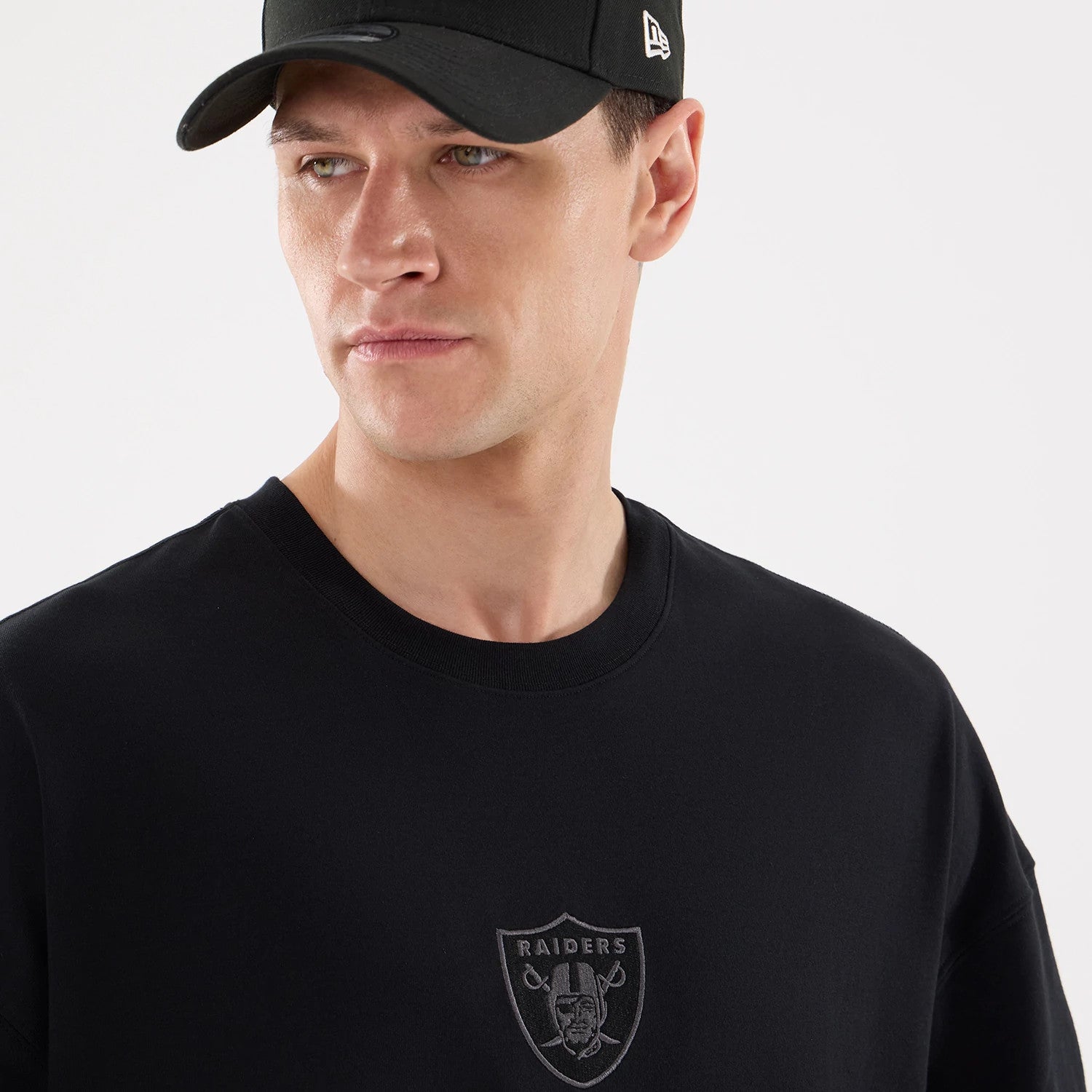 The model is wearing this NFL Raiders Wear Las Vegas Raiders Oversized T-Shirt in black. 4