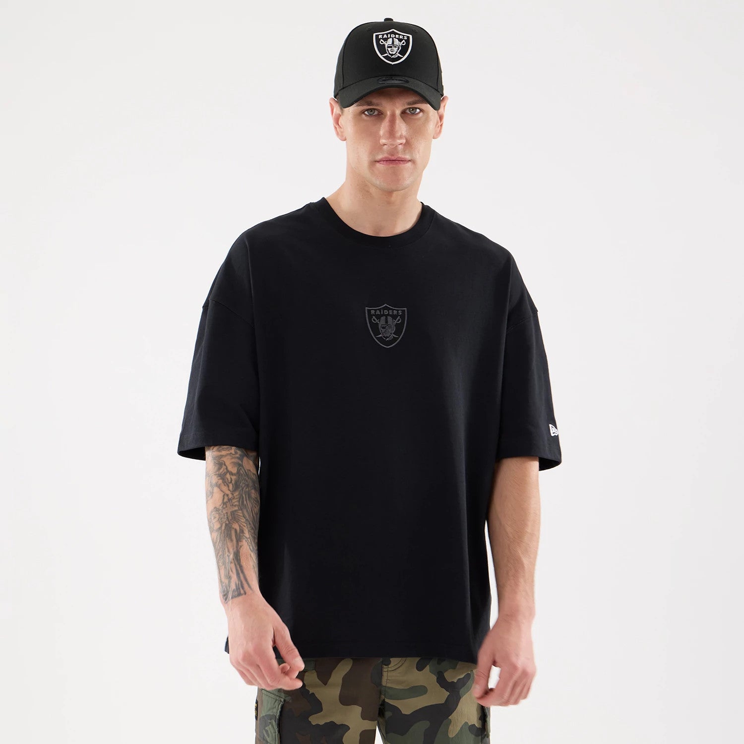 The model is wearing this NFL Raiders Wear Las Vegas Raiders Oversized T-Shirt in black. 1