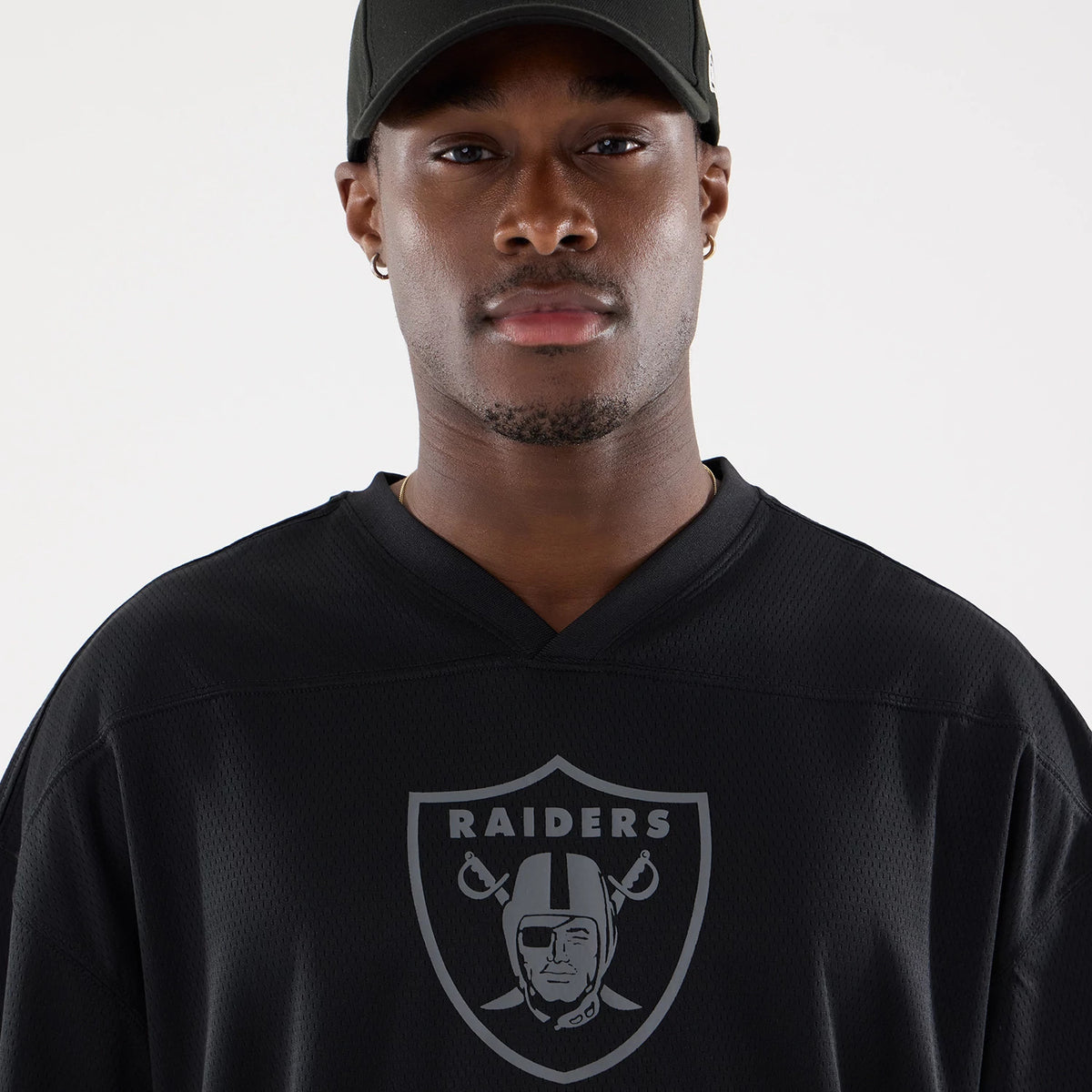 The model is wearing this NFL Raiders Wear Black Las Vegas Raiders Mesh Oversized T-Shirt in black. 4
