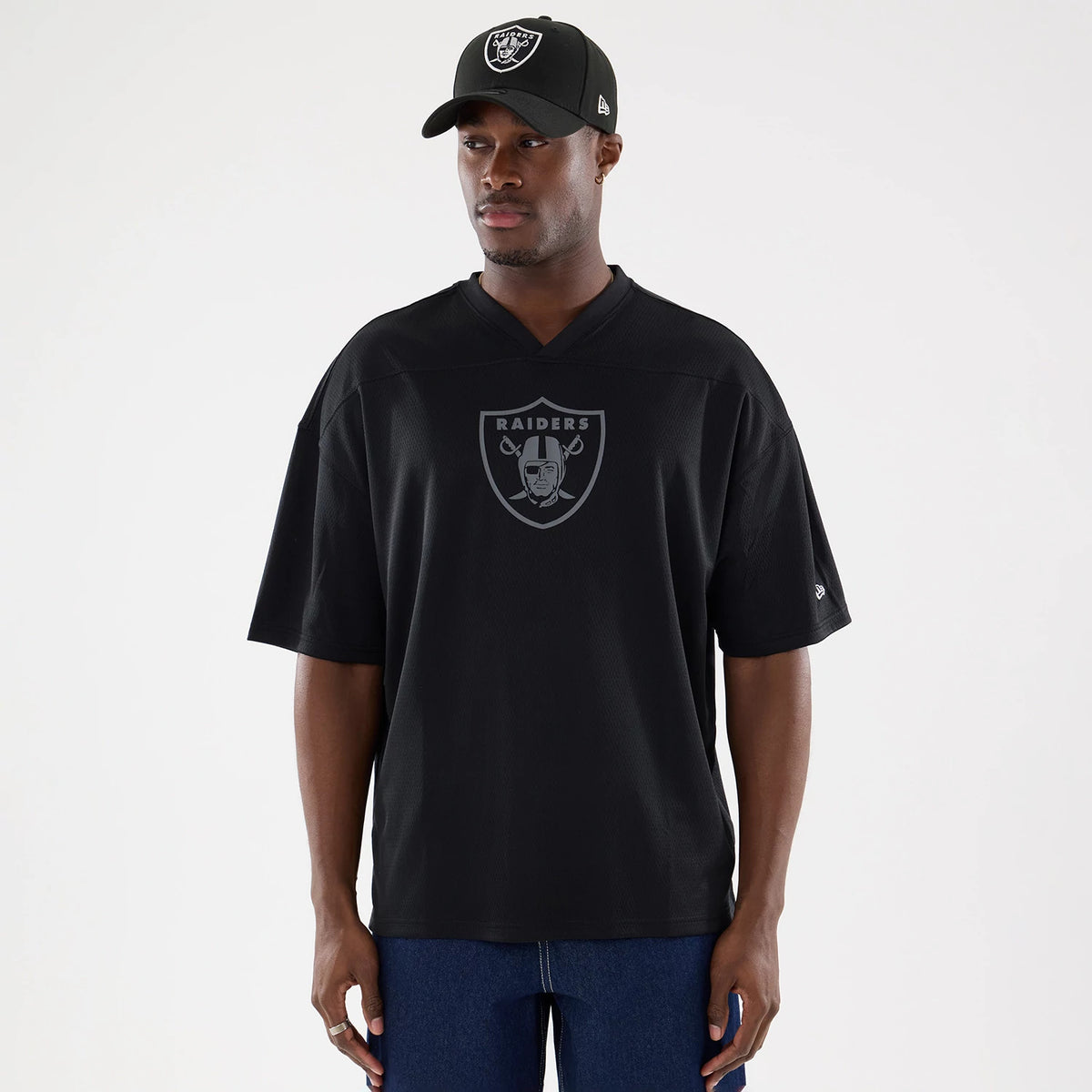 Las Vegas Raiders NFL Raiders Wear Black Mesh Oversized T-Shirt, on-model view showing the large Raiders logo centred on the chest, loose short sleeves, and a small debossed New Era logo on the left sleeve.