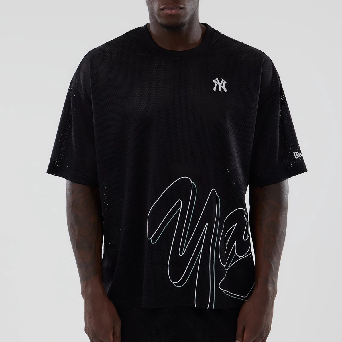 New York Yankees MLB Mix League Black Oversized Mesh T-Shirt, front view showing the white New York Yankees logo on the chest, white oversized script across the lower half, and a raised New Era logo on the left sleeve.