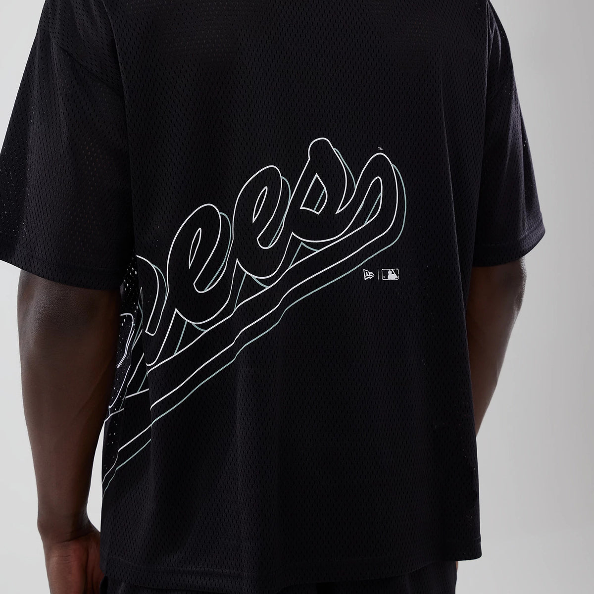 New York Yankees MLB Mix League Black Oversized Mesh T-Shirt, rear view showing the large white script logo across the back with small raised New Era and MLB logos beneath, set against the black mesh fabric.