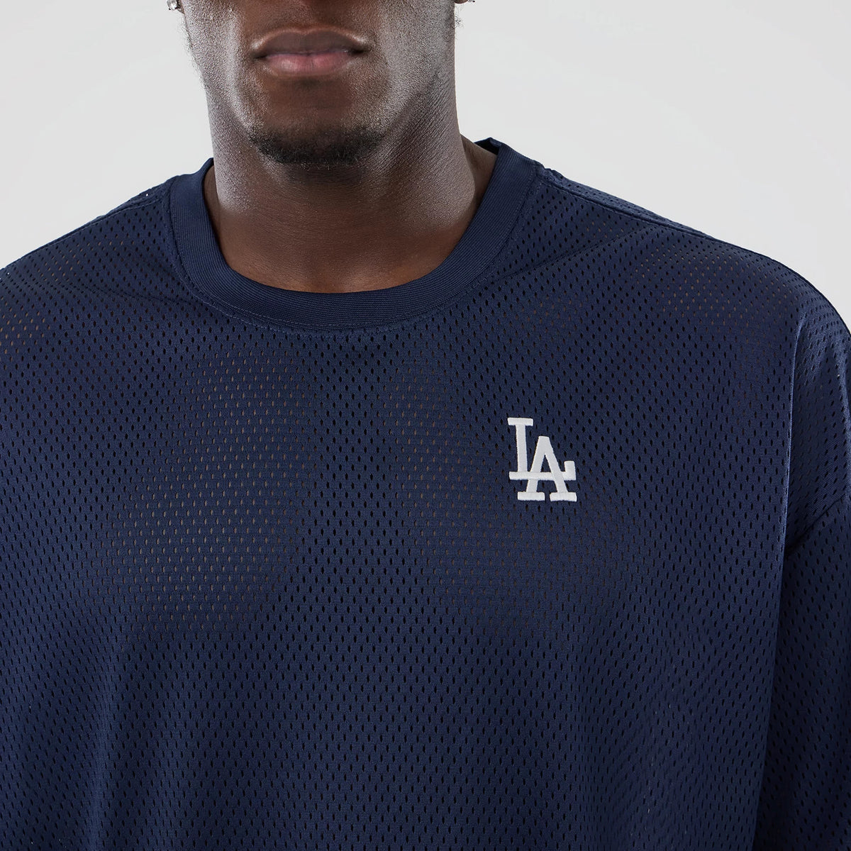 LA Dodgers MLB Mix League Blue Oversized Mesh T-Shirt, front view showing the navy mesh fabric with a white raised LA logo on the left chest, highlighting the oversized cut and round neckline.