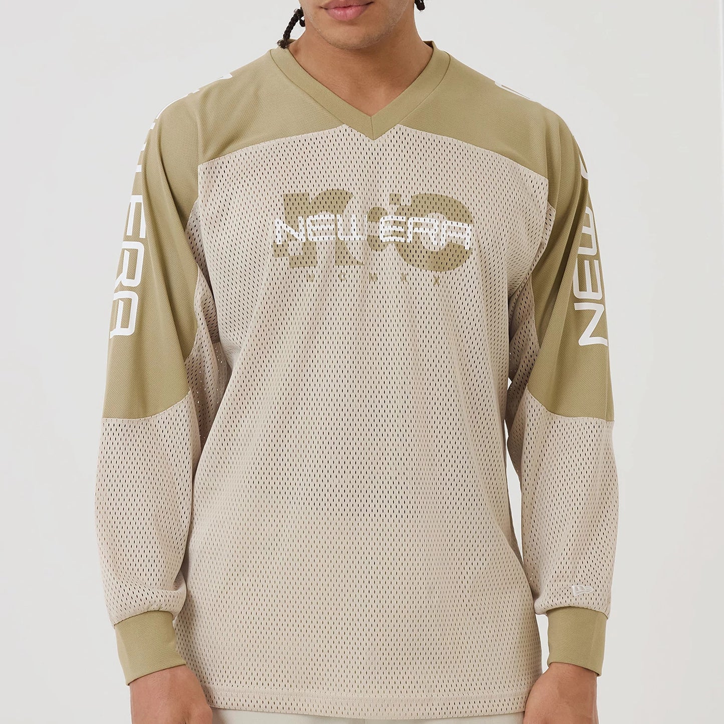 The model is wearing this New Era NEC Logo Long Sleeve Jersey in beige/khaki. 8