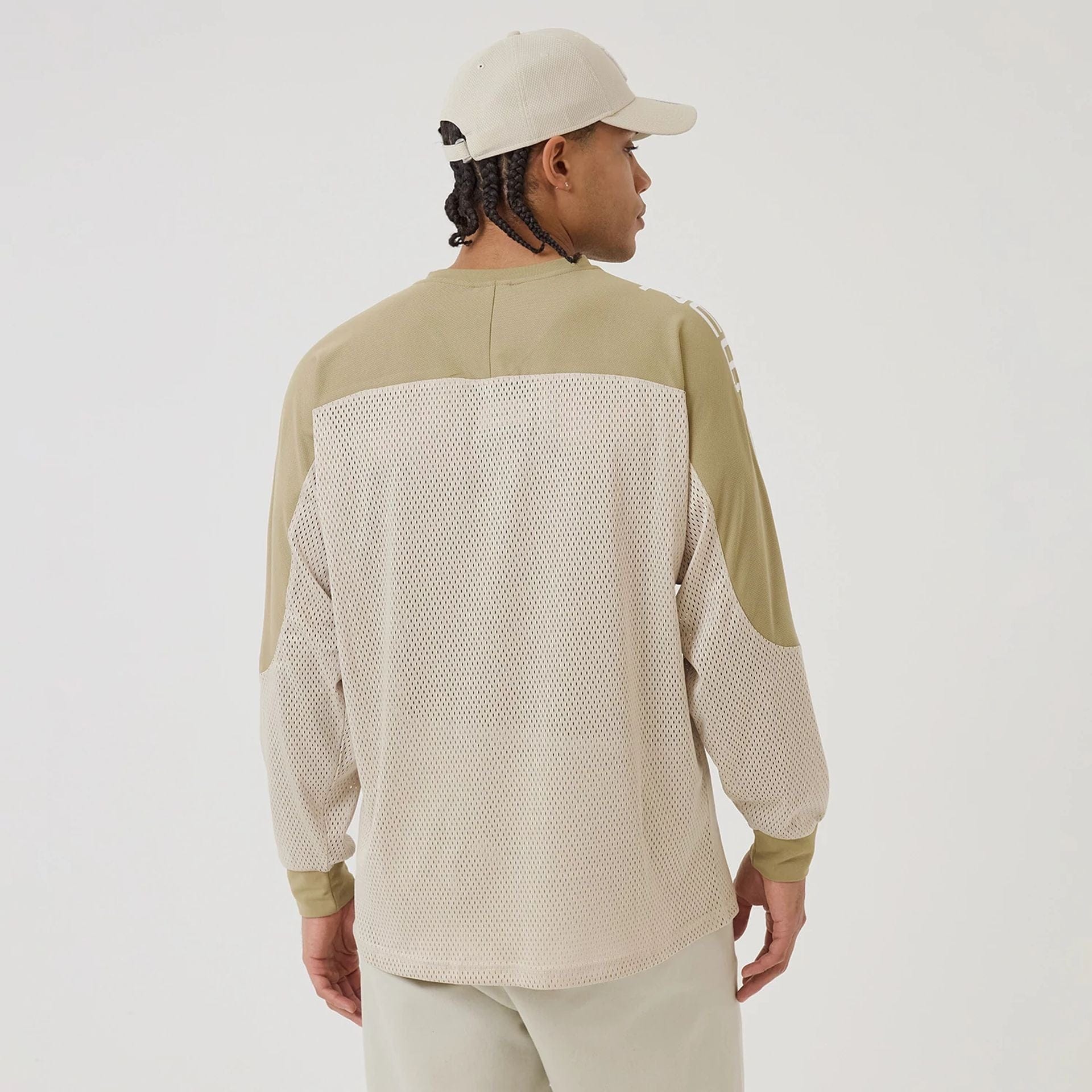 The model is wearing this New Era NEC Logo Long Sleeve Jersey in beige/khaki. 2