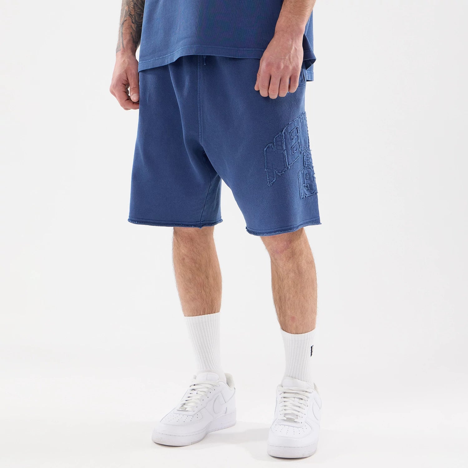 The model is wearing this New Era Street Archived Oversized Shorts in blue. 1