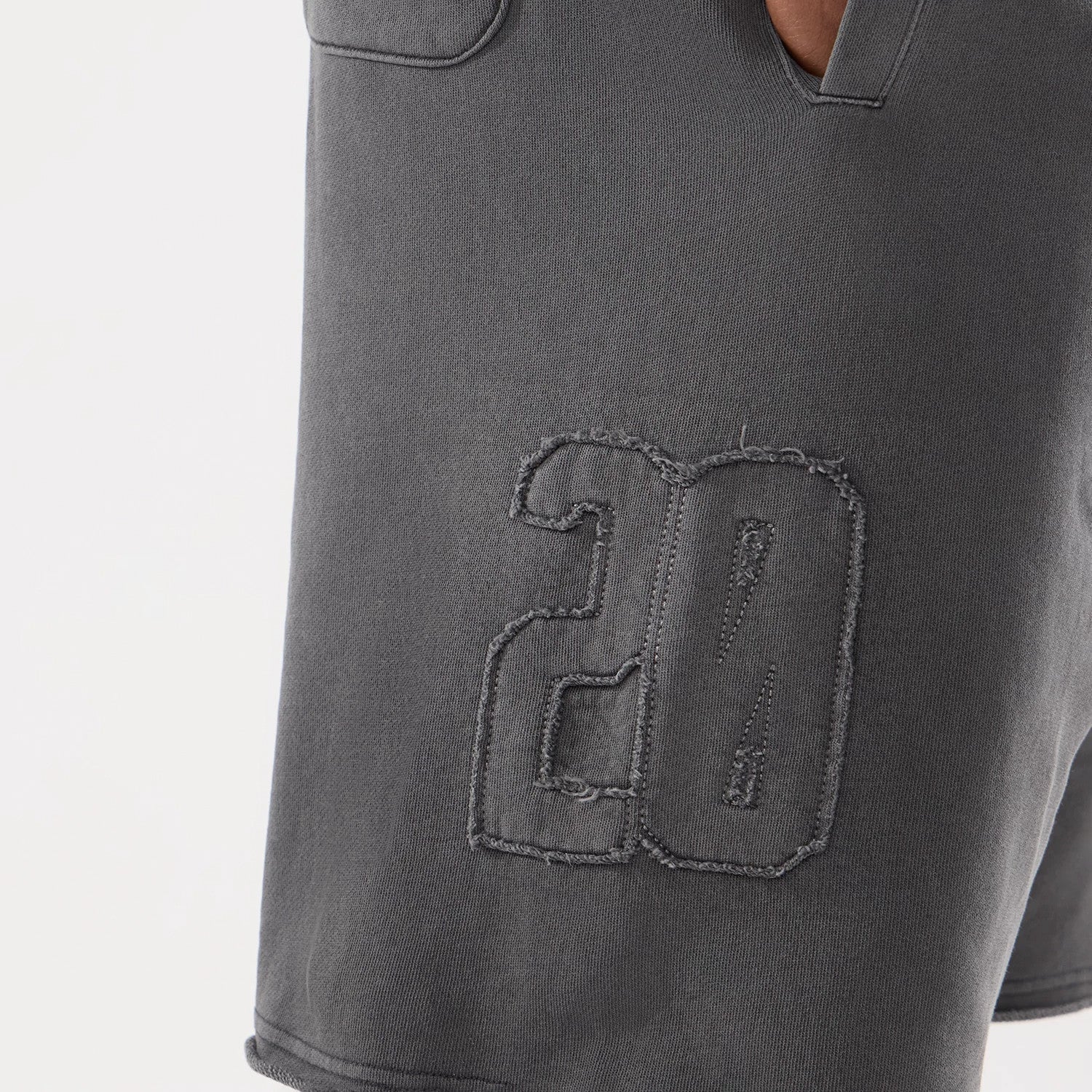 The model is wearing this New Era Street Archived Oversized Shorts in black. 4