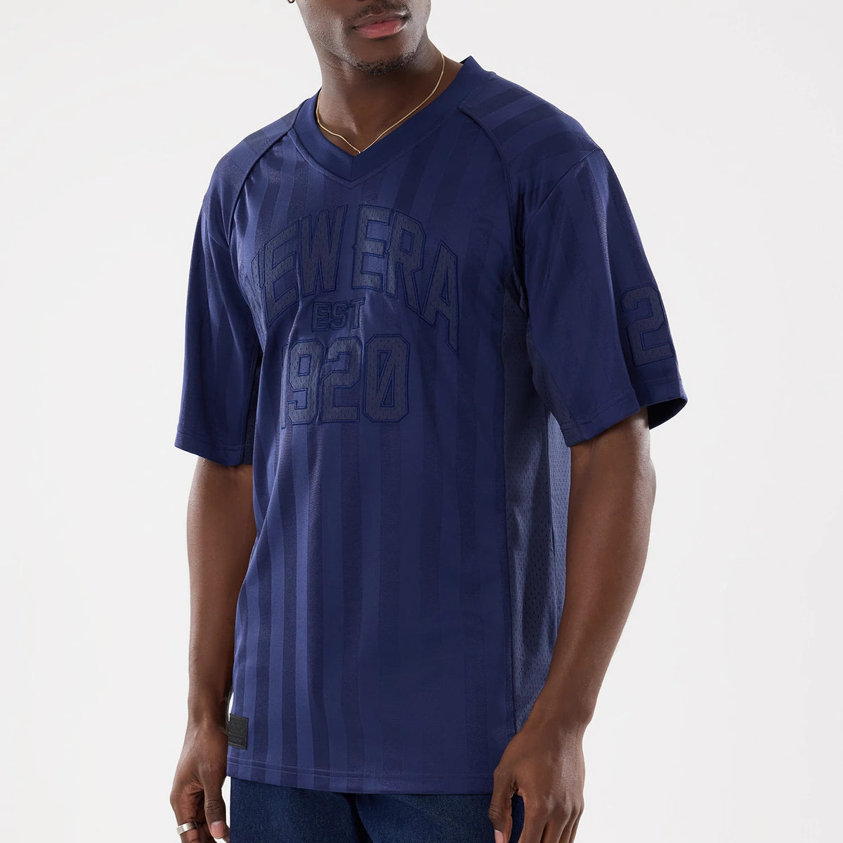 New Era Street Archived Navy Mesh Jersey, front view on a model showing the navy New Era EST 1920 lettering across the chest with mesh side panels and the number 20 embroidered on the left sleeve.