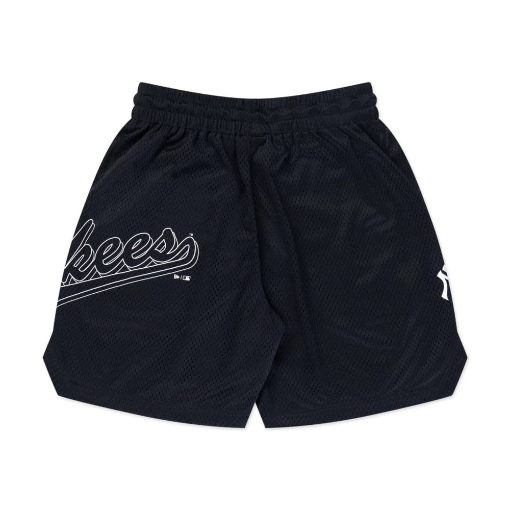 The model is wearing this MLB Mix League New York Yankees Oversized Mesh Shorts in black. 8