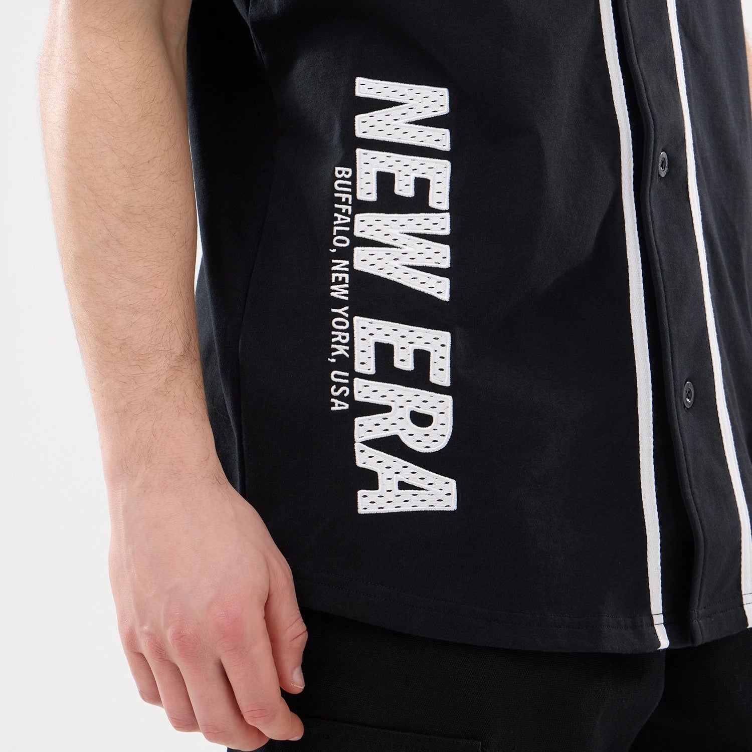 The model is wearing this New Era Basic Jersey in black. 3