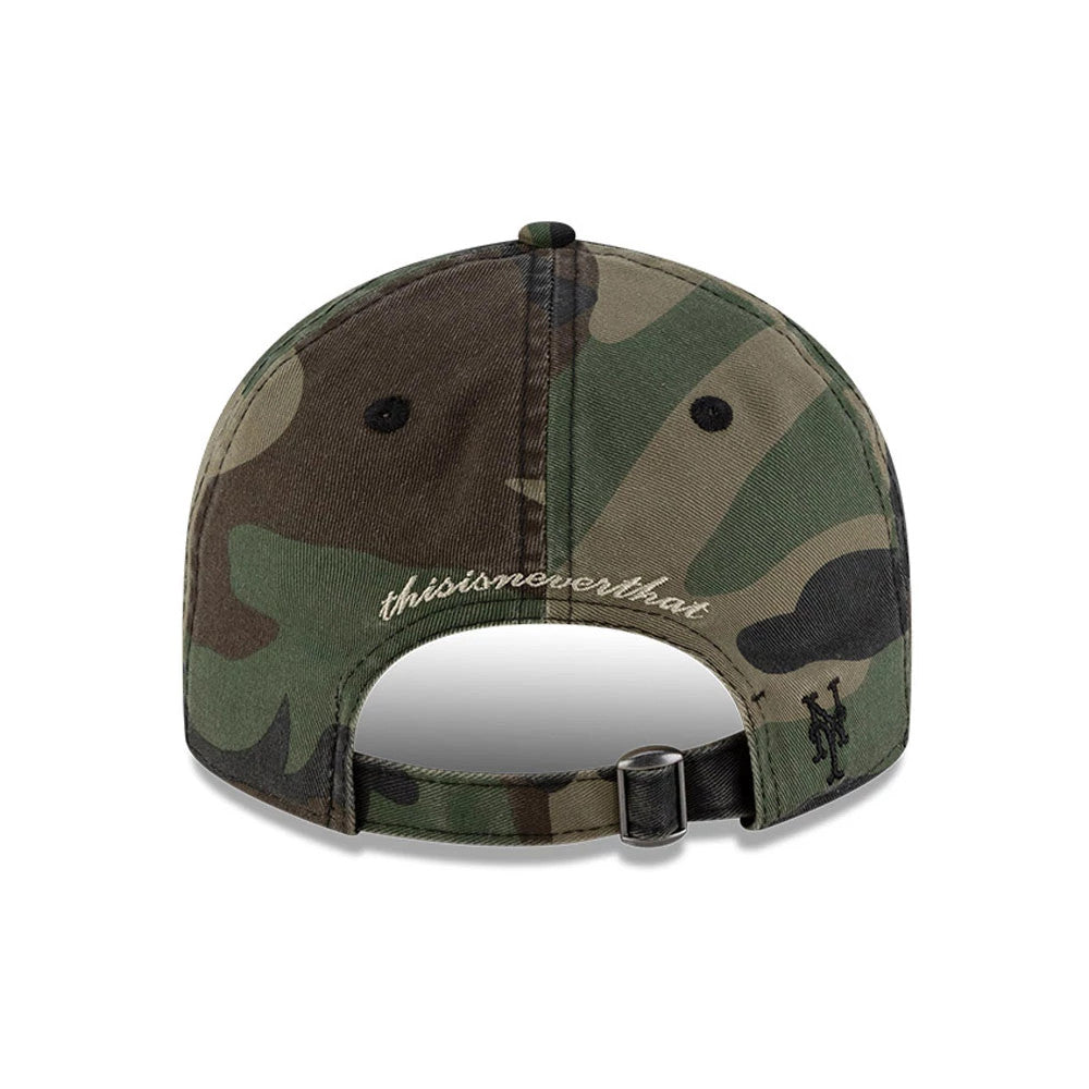 New York Mets Thisisneverthat X MLB Woodland Camo Retro Crown New Era 9FIFTY Cap, rear view showing the embroidered thisisneverthat lettering above the adjustable strap and the Mets logo embroidered on the side, set on a camo pattern crown.