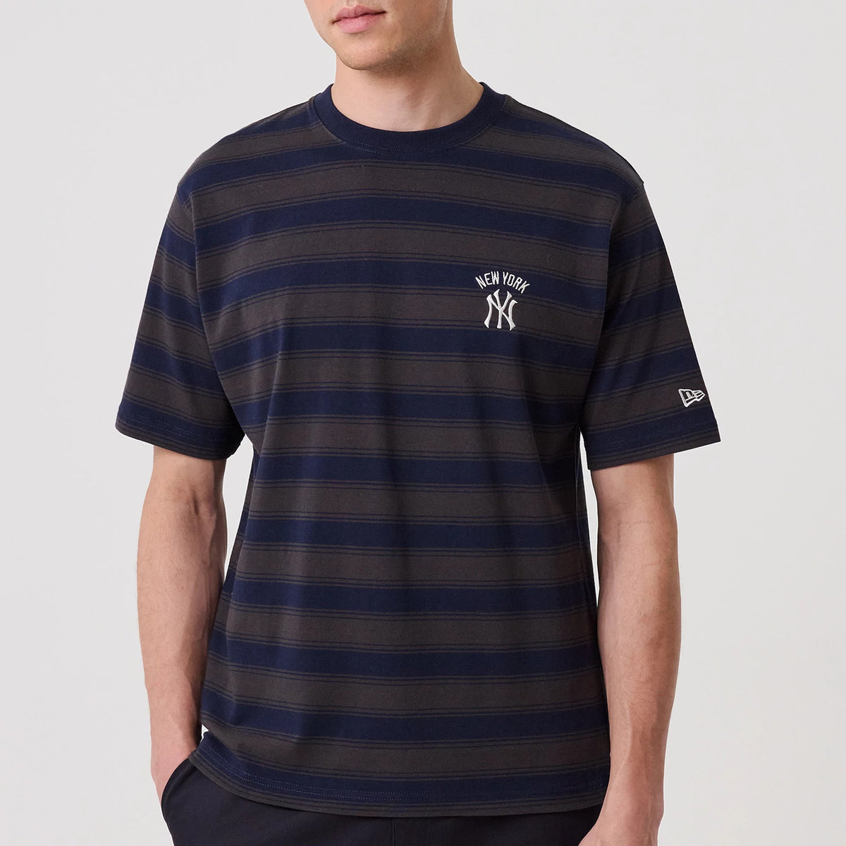 New York Yankees MLB Border Navy Oversized T-Shirt, front view showing navy horizontal stripes, a small raised New York Yankees logo on the left chest, and a New Era flag on the left sleeve.