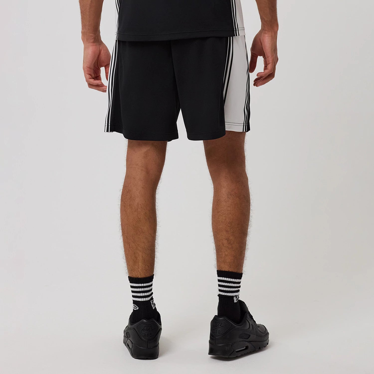 The model is wearing this New Era Mesh Shorts in black. 2