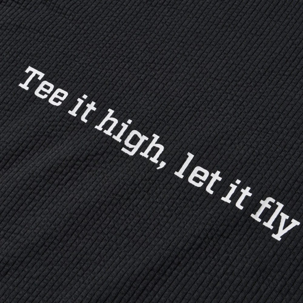 The model is wearing this New Era Seersucker Polo T-Shirt in black. 8