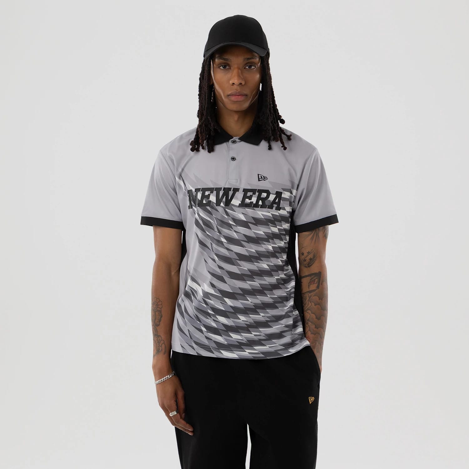 The model is wearing this New Era Grid Polo T-Shirt in grey. 1