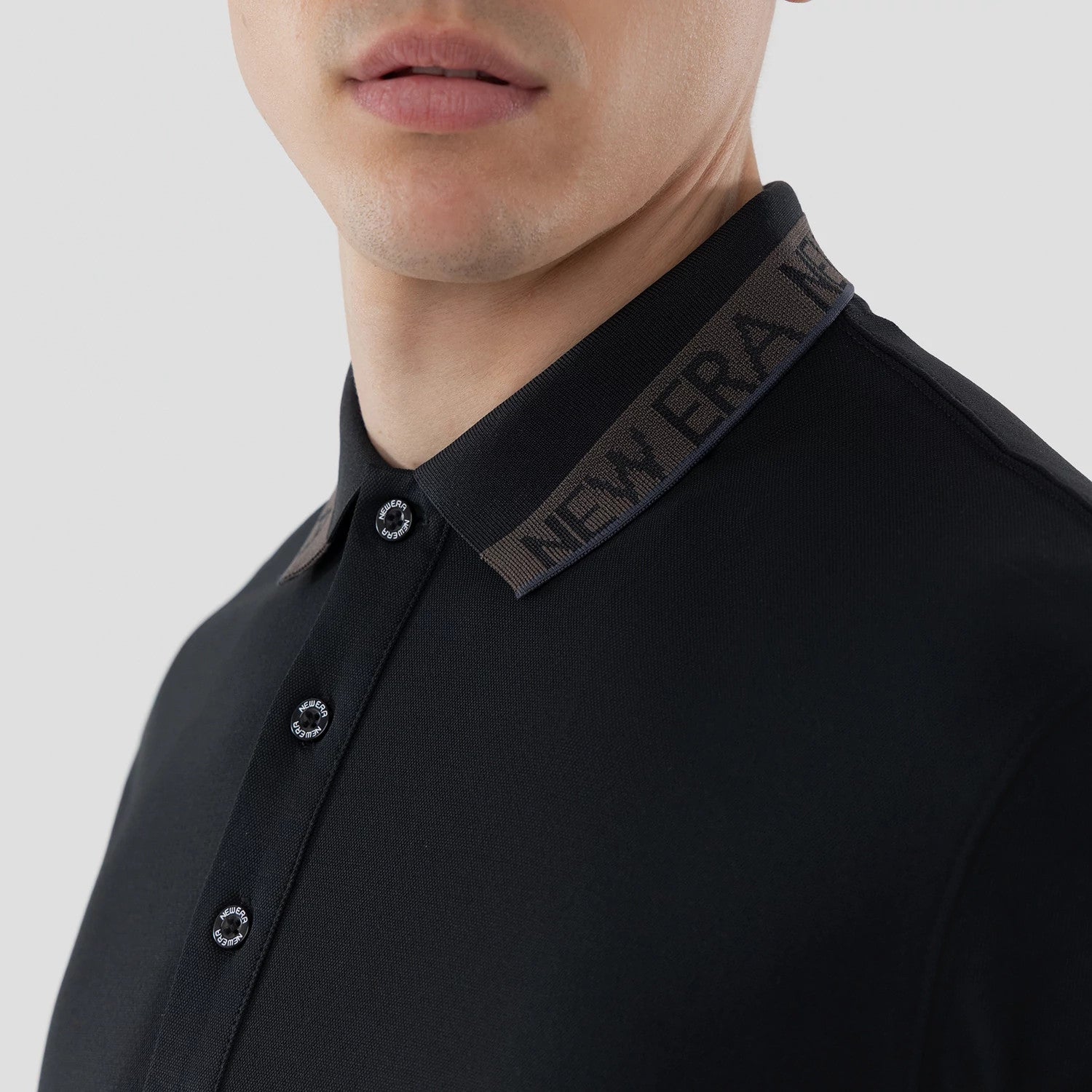 The model is wearing this New Era Kanoko Polo T-Shirt in black. 5