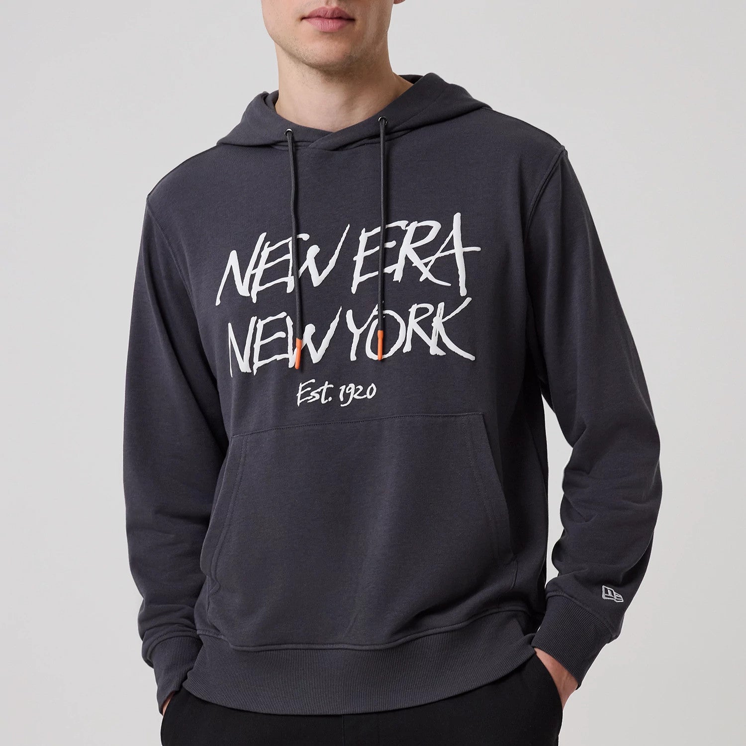 The model is wearing this New Era New York Oversized Pullover Hoodie in dark grey. 4