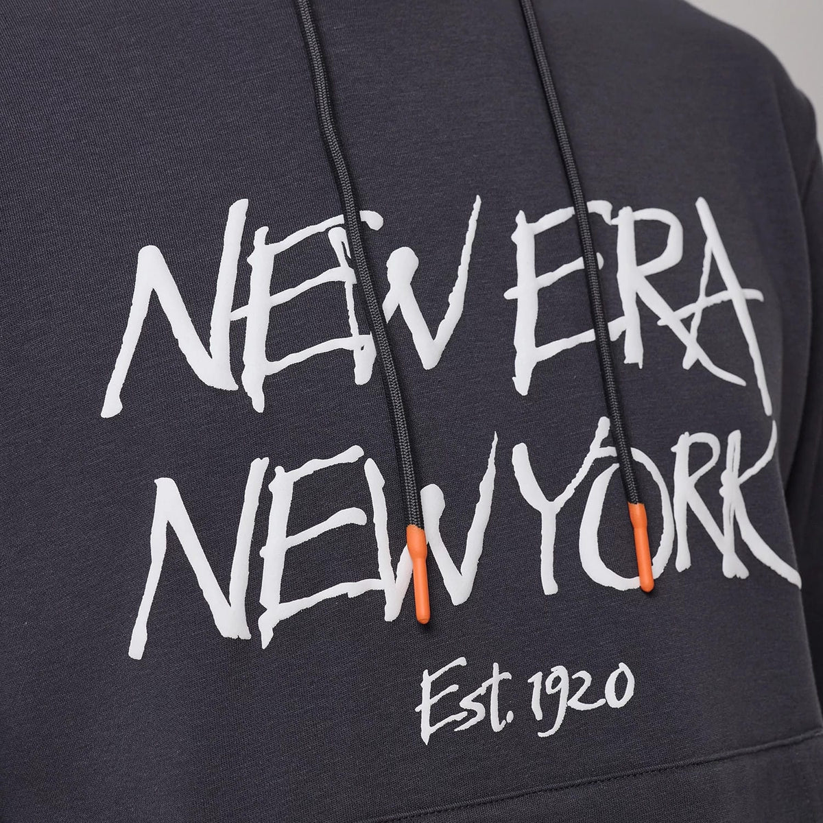 The model is wearing this New Era New York Oversized Pullover Hoodie in dark grey. 3