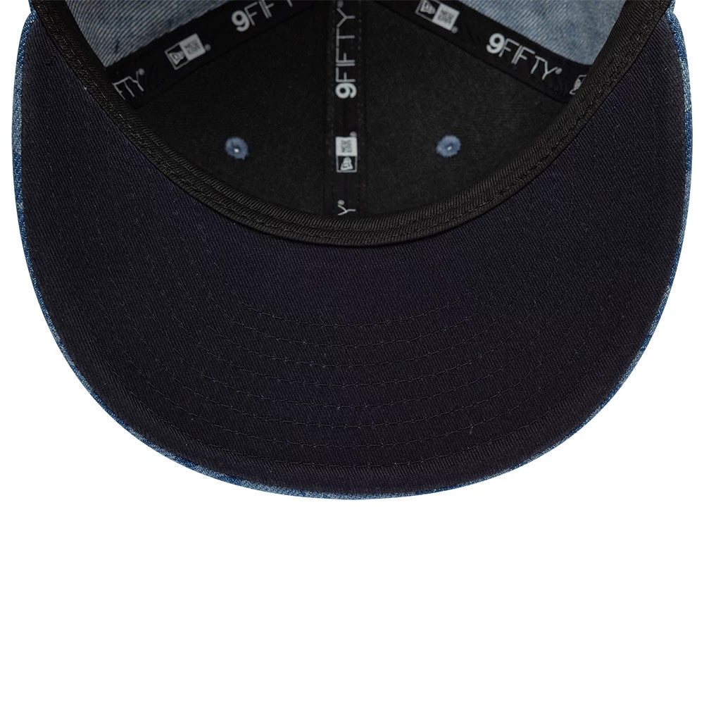 New Era Laser Burnout Washed Denim Navy 9FIFTY Snapback Adjustable Cap, inside view showing the black sweatband with 9FIFTY and New Era branding, black undervisor, and contrasting blue taping along the inner seams.
