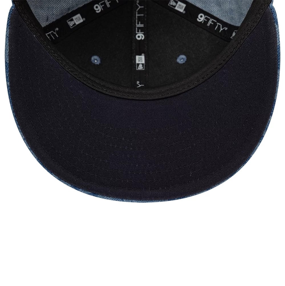 Pictured is this New Era Laser Burnout Washed Denim 9FIFTY Snapback Adjustable cap in navy. 2