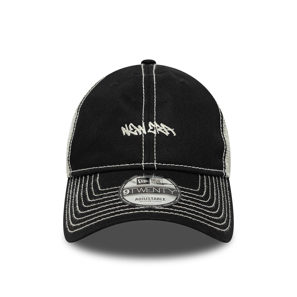 New Era Tagging Logo Black New Era 9TWENTY Trucker Adjustable Cap, front view showing the white embroidered graffiti-style logo on the structured black front panel with white contrast stitching and a 9TWENTY size sticker on the curved visor.